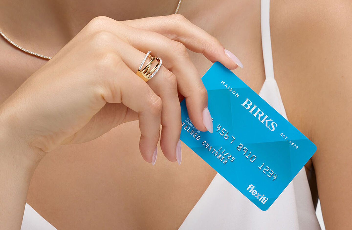 A woman holding a Maison Birks Flexiticard.
